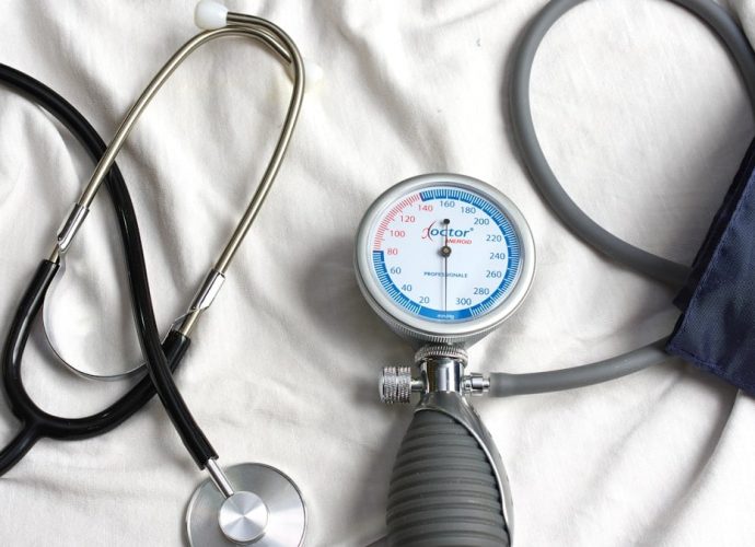 a stethoscope laying on top of a bed next to a medical bag