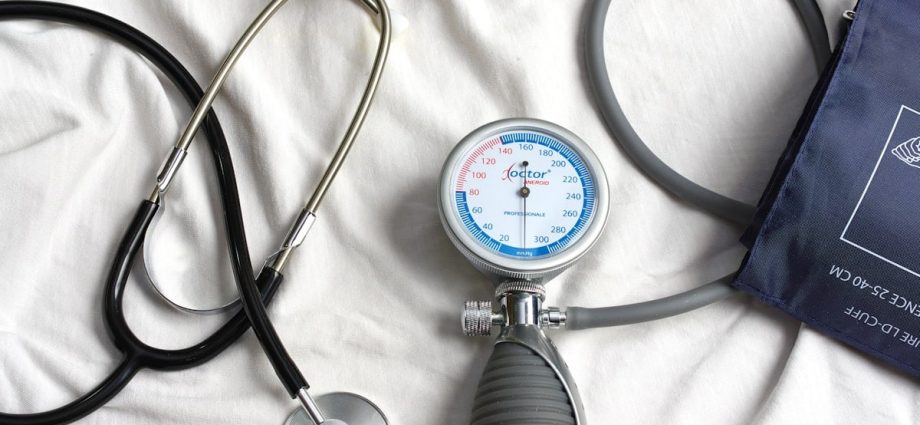 a stethoscope laying on top of a bed next to a medical bag
