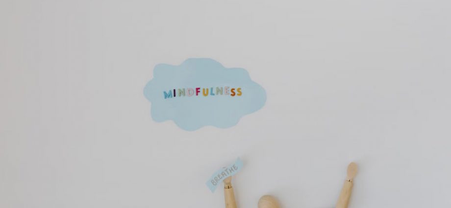 Wooden figure promoting mindfulness and breathing on a clean white background.